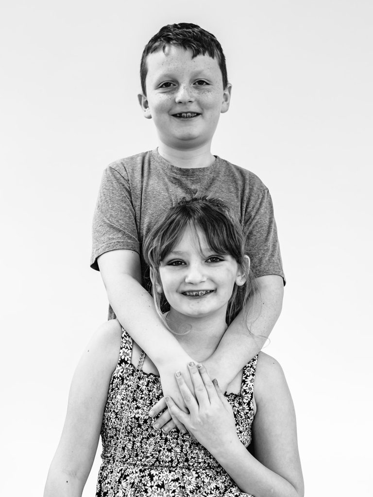 Buffalo personality portraits of three siblings showing unique individual characters in black and white