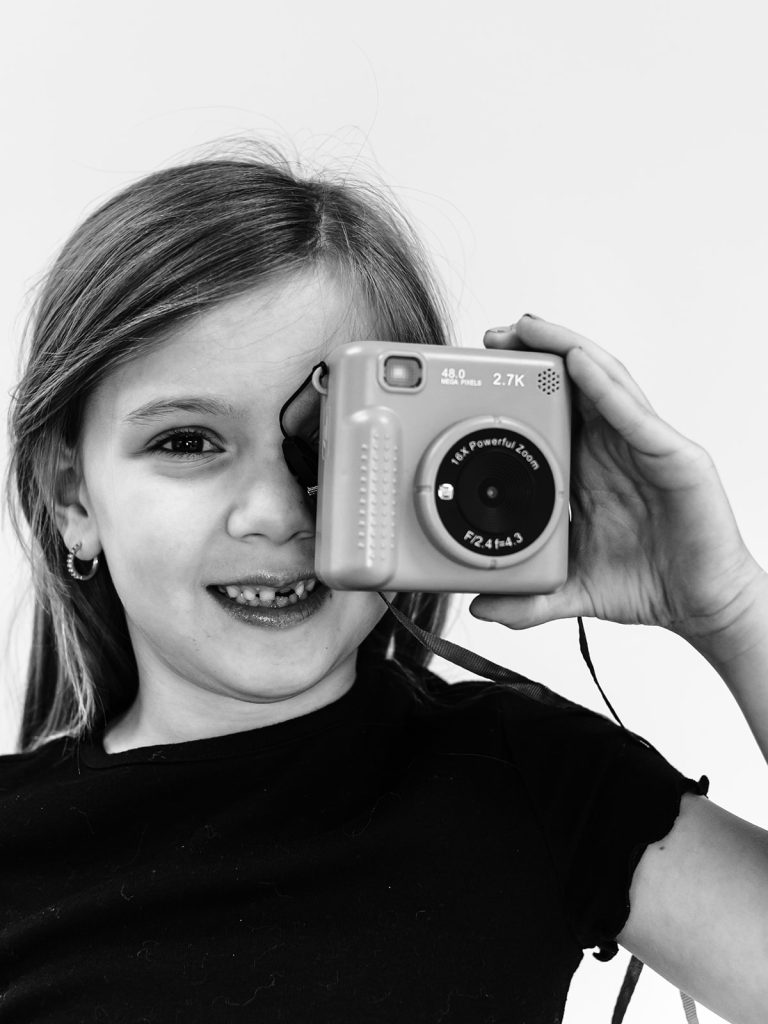 Buffalo personality portrait of smiling child with gap-toothed grin captured in beautiful black and white