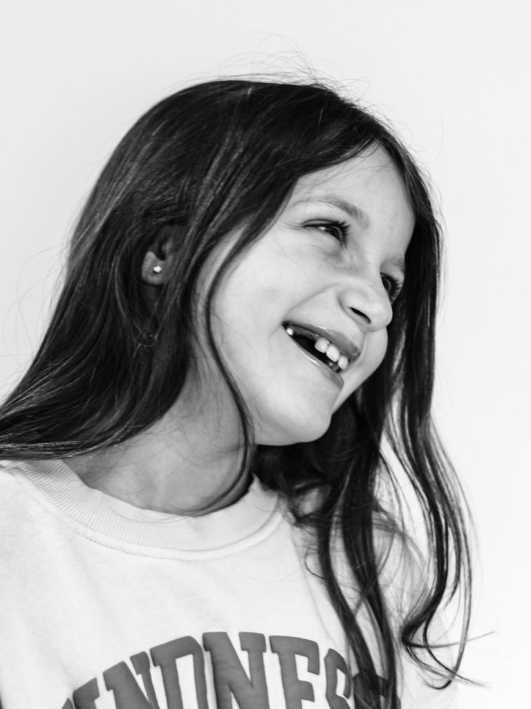 Black and white personality portrait of Buffalo child with authentic smile captured during individual photography session