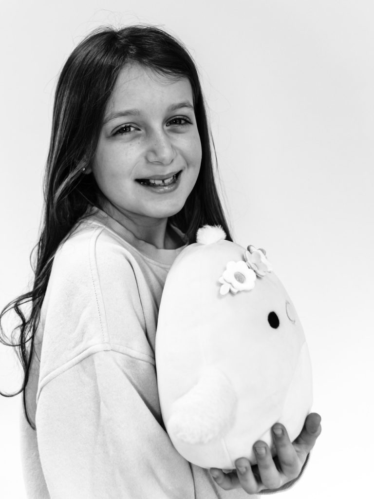 Black and white personality portrait of Buffalo child with authentic smile captured during individual photography session