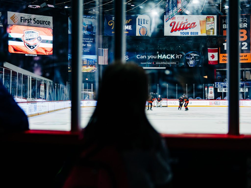 Buffalo photographer for hockey families arriving for in-home documentary session in Western New York showing welcoming professional approach