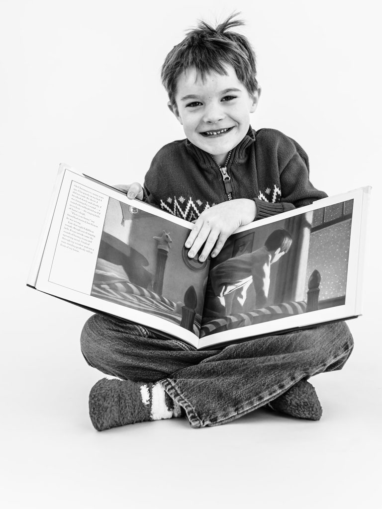 Boy showing genuine personality in black and white portrait by Buffalo photographer