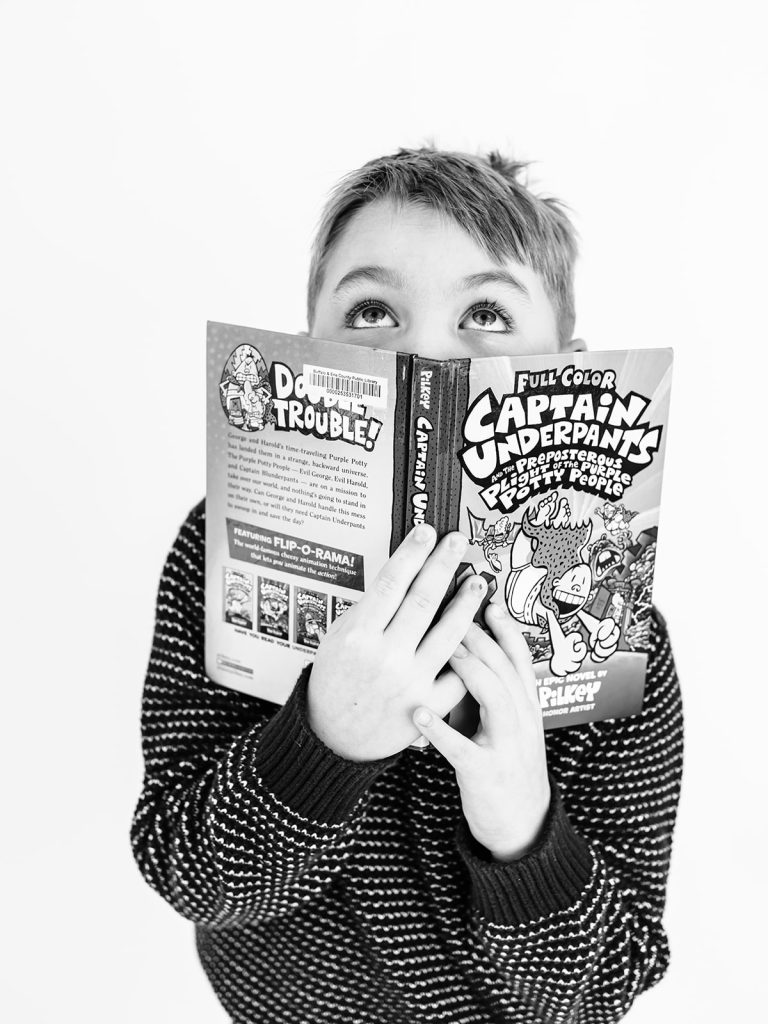 Boy showing genuine personality in black and white portrait by Buffalo photographer