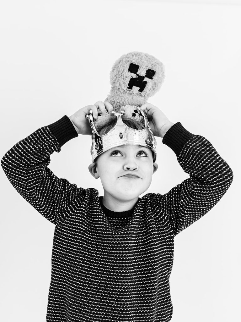 Boy showing genuine personality in black and white portrait by Buffalo photographer