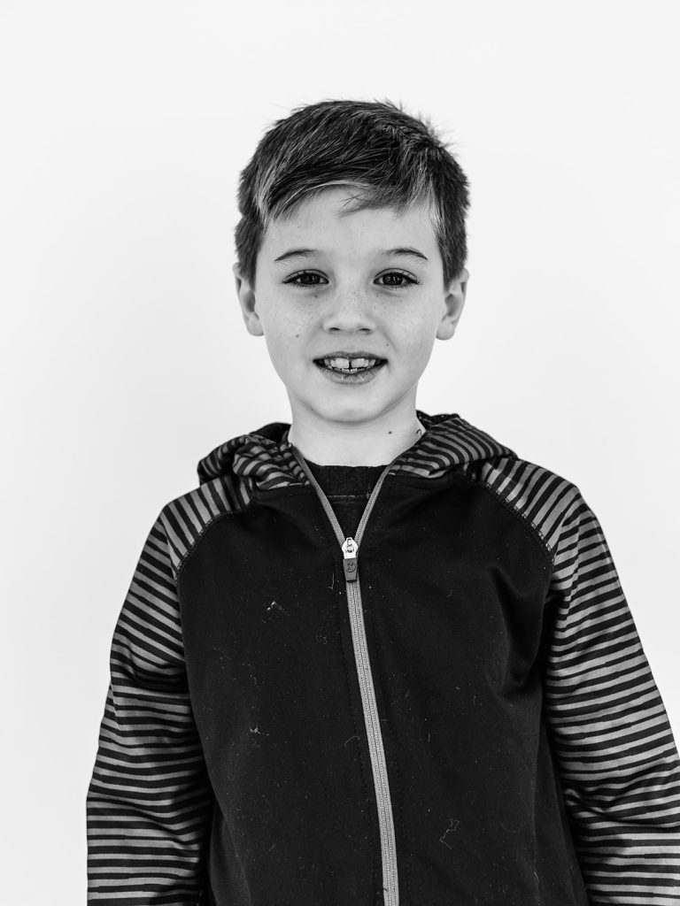 Boy showing genuine personality in black and white portrait by Buffalo photographer