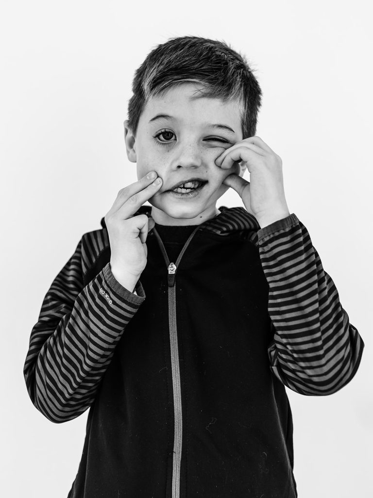 Boy showing genuine personality in black and white portrait by Buffalo photographer