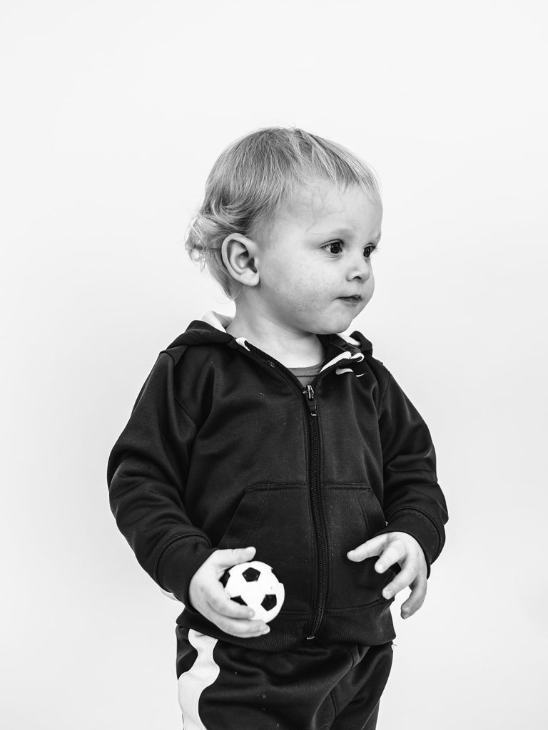 Boy showing genuine personality in black and white portrait by Buffalo photographer