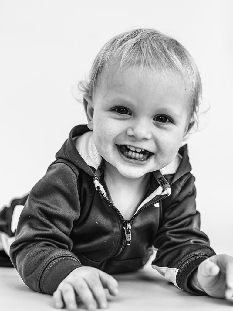Boy showing genuine personality in black and white portrait by Buffalo photographer