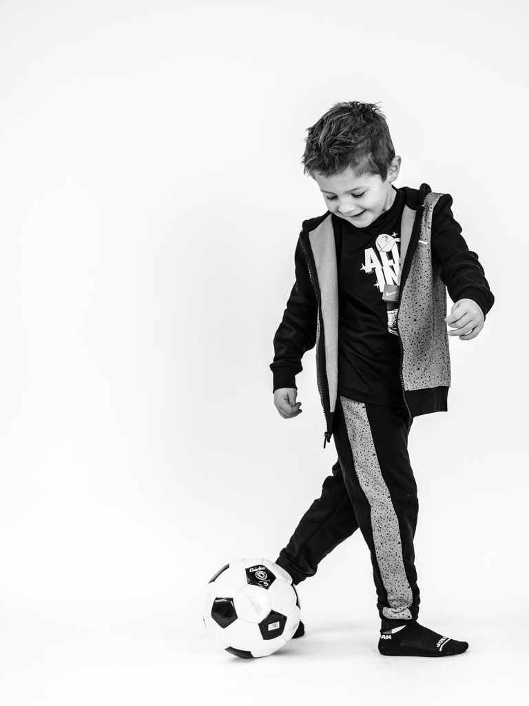 Child playing with props during individual personality portrait session
