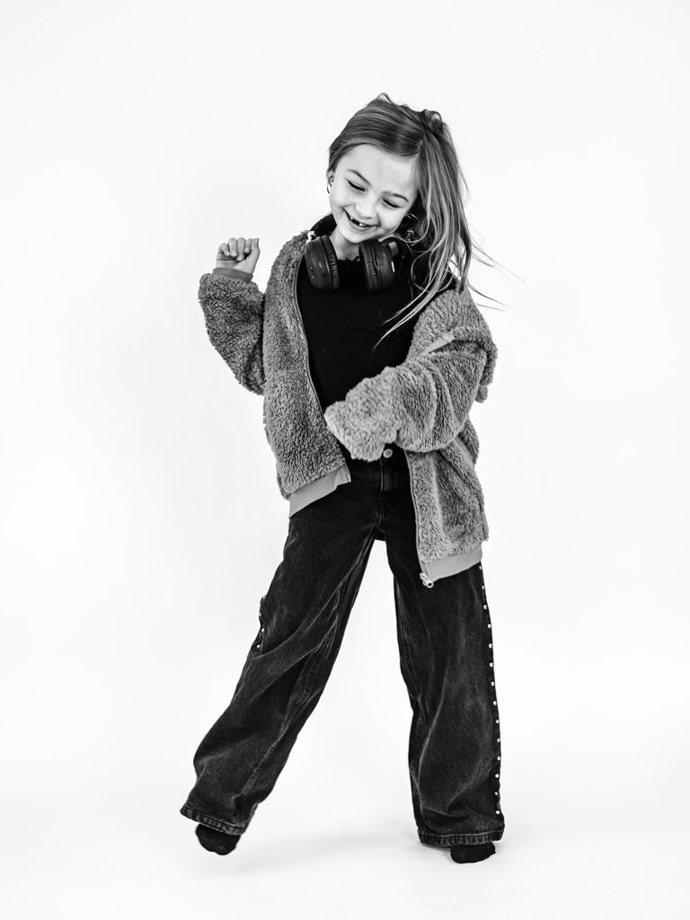 Child playing with props during individual personality portrait session