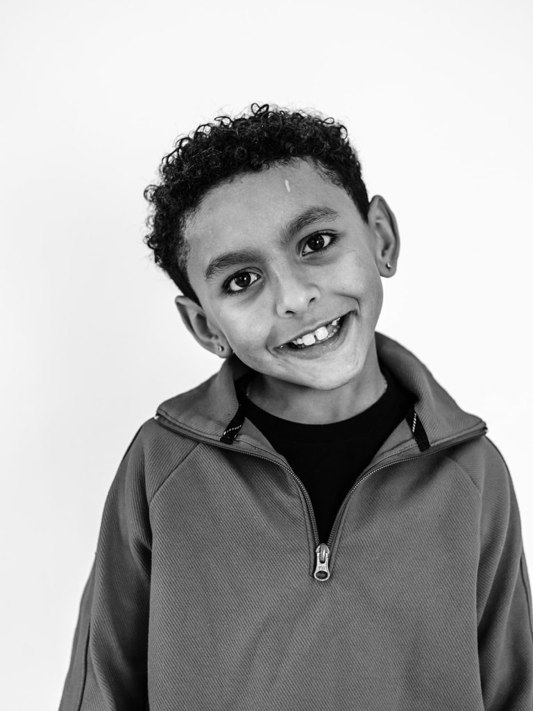 Thoughtful expression on child during individual personality portrait session