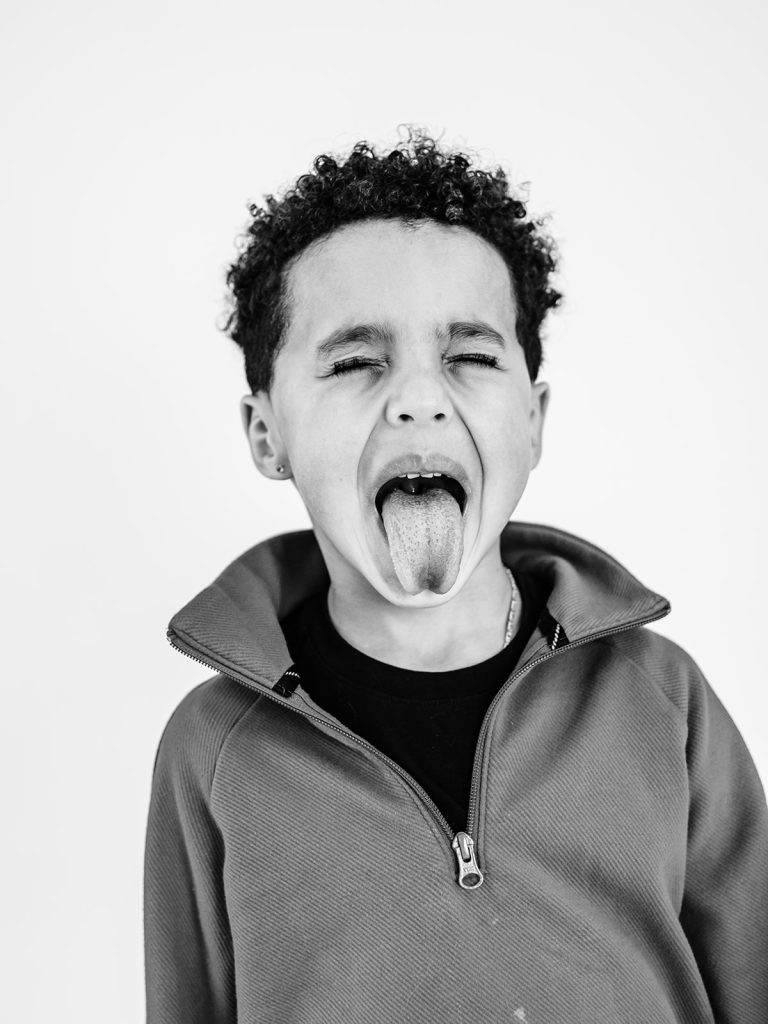 Playful expression on child during individual personality portrait session