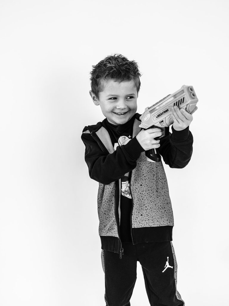 Child playing with props during individual personality portrait session