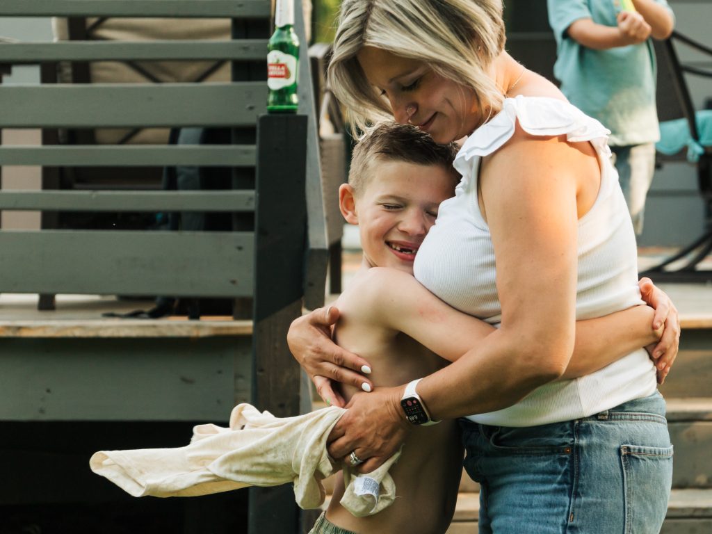 Grand Island Mom hugging her son