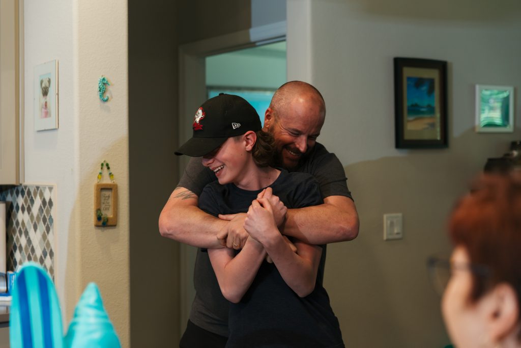 father and son rough housing during documentary family film Buffalo NY